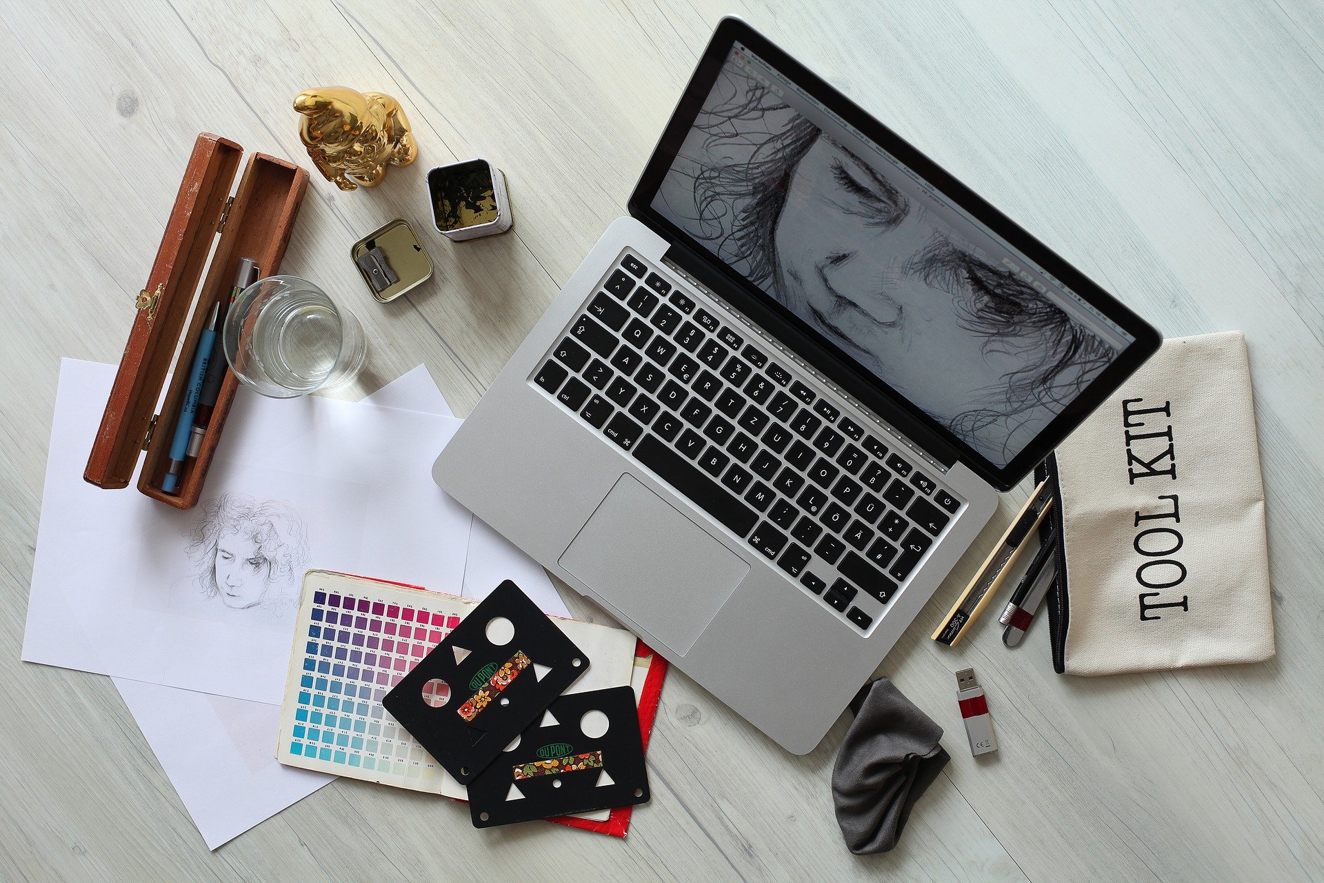 Desk with digital artwork and art materials